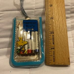 Mini Snoopy pencil and pad set on a string.